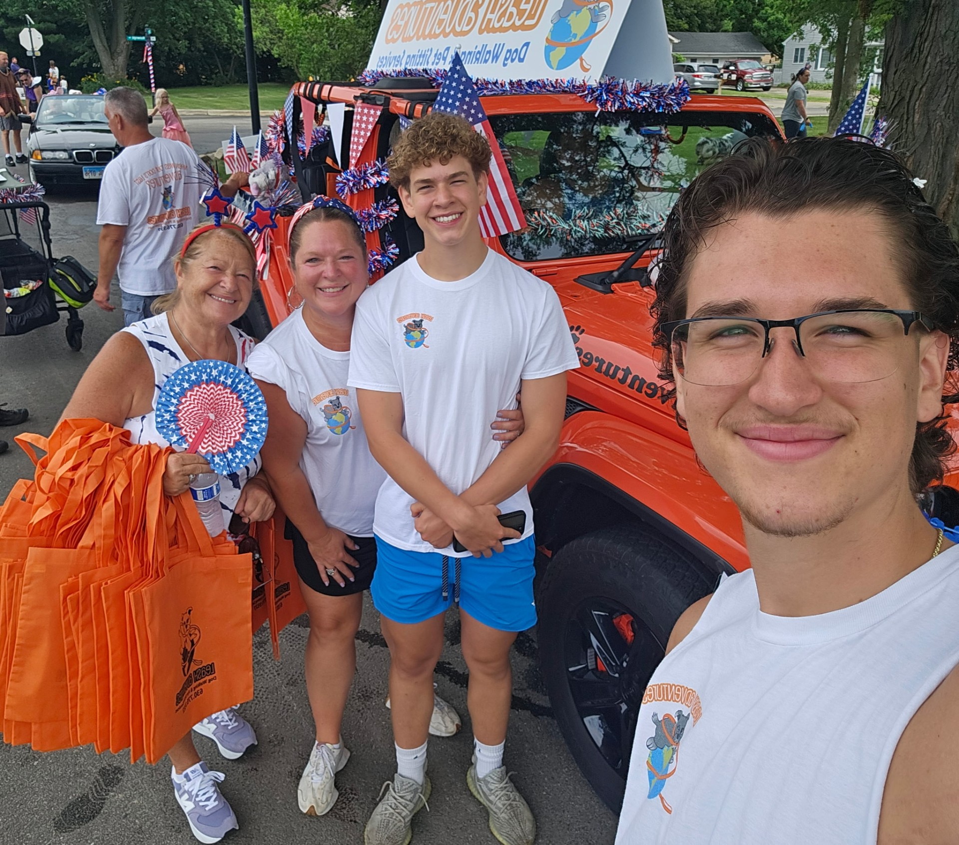 Leash Adventures team selfie with the decorated parade Jeep on the 4th of July in Elmhurst, IL